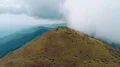 The flight above a picturesque mountain on a cloud background 4k or 4k+ Resolution