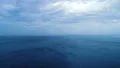 The flight above the picturesque ocean on the cloud stream background 4k or 4k+ Resolution