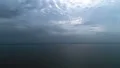 The flight above the picturesque sea on the rainy cloud background. time lapse 4k or 4k+ Resolution