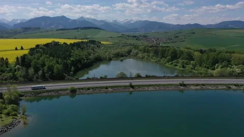 Flight above road across river dam Liptovska Mara during summer season Stock Footage 137437491