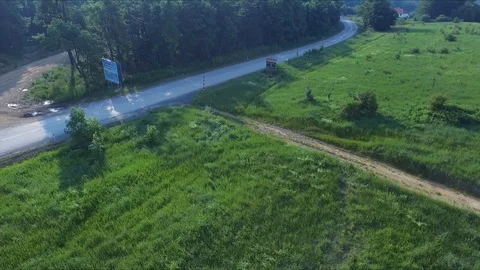 Flight above the road that goes through the mountain 스톡 동영상 111376267