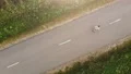 The flight above the road with a running sportsman. quadrocopter shot 4k or 4k+ Resolution