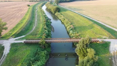 Flight above rusty bridge towards small hydroelectric powerplant. Stock Footage 137438212