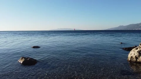 Flight above the sea surface and beach 動画素材 150116802