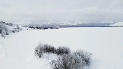 Flight above snow-covered lake after snowfall. Video stock 150993617