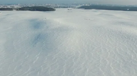 Flight above snow fields in winter, aerial panoramic view. Stock Footage