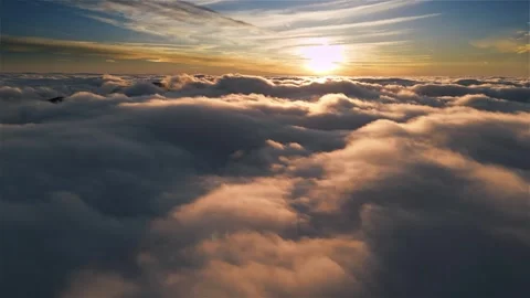 Flight above soft morning clouds at golden sunrise, dreamy aerial landscape Stock Footage 307709325