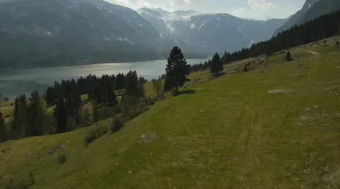 Flight above trees against mountain lake Stock-Footage 44904951