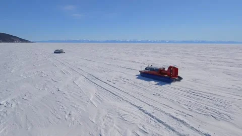 Flight above two Hivus hovercrafts frozen lake winter expedition Polar adventure Stock Footage 316108071