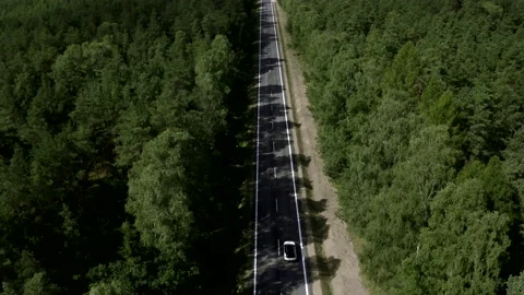 Flight Above A Two Lane Road With Cars In The Middle Of The Green Forest Stock Footage 142000306