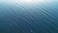 The flight above the water on the picturesque sunset background. drone shot 4k or 4k+ Resolution