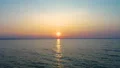 The flight above the water on the sunrise background. drone shot 4k or 4k+ Resolution