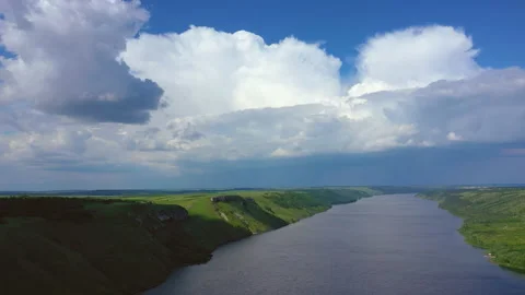 Flight above wide river between green mountains Stock Footage 160222816