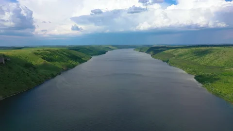 Flight above wide river between green mountains Stock Footage 160222863