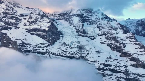 Flight Above winter Alps, alpine Mountain Range in Winter, epic Snowy peaks at Stock Footage 221735989