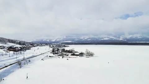 Flight above winter road and snow-covered lake. Stock Footage 150993605