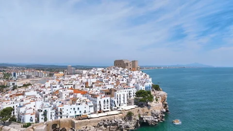 Flight across the densely packed low rise white apartment blocks of Peniscola Video stock 344181074