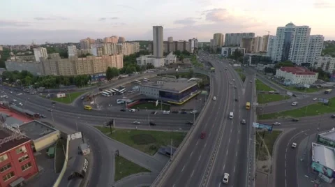 Flight across the road junction in the city on the sunset Stock Footage 64372937