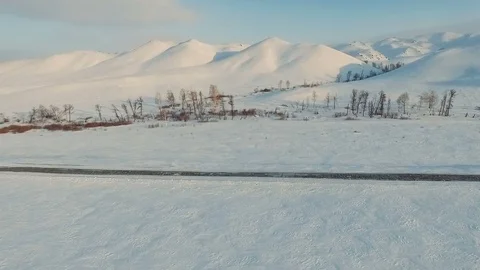 Flight across a winter road to the mountains. Stock Footage 70382459
