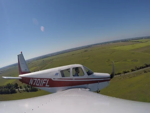 Flight on an airplane. Low flight nex to trees and road. Stock Footage 71324193