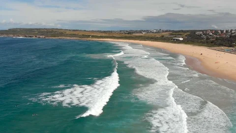 Flight along big, long waves hitting a beach, Sydney, Australia, 4K Stock Footage 105589164