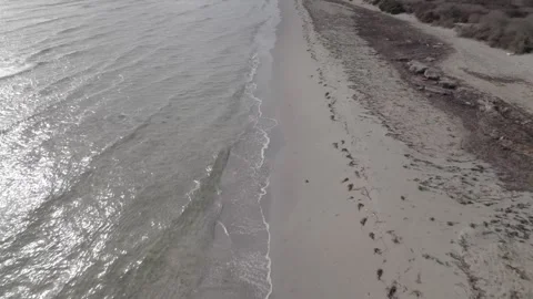 Flight along an empty, picturesque beach with the hull of a shipwreck Stock Footage 243020600