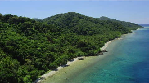 Flight along forest covered coast line with tropical ocean Stock-Footage 25364069