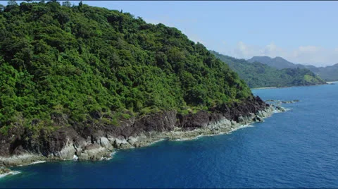 Flight along a forets covered hilly coast line Stock Footage 25361935