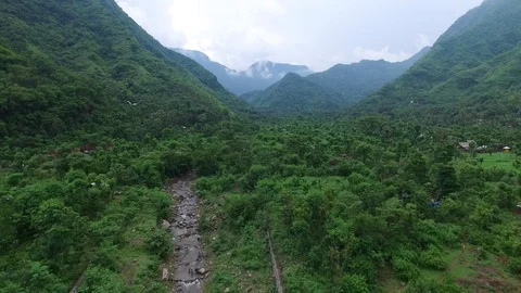 Flight along mountains covered with rainforest Stock Footage 108680217