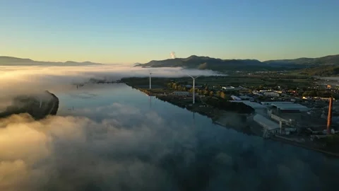 A flight along the Rhone River overlooking the town of Le Pouzin with thick fog Stock Footage 219964877