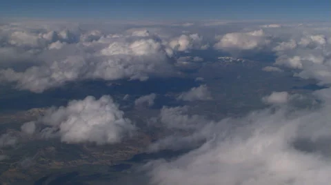 Flight alongside puffy clouds, passenger POV Stock Footage 59450515