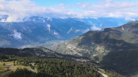 Flight in an alpine valley with snow-capped peaks in the background Stock Footage 138881355