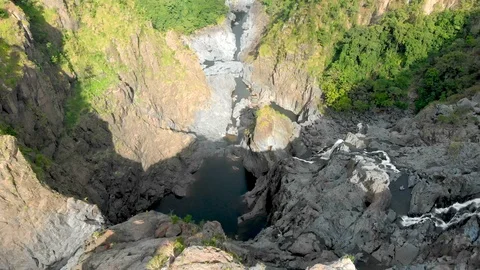 Flight and diving into Barron Falls waterwall, Cairns, Australia, 4K Stock Footage 106826636