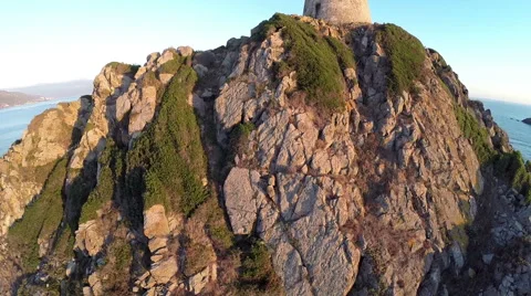 Flight and takeoff over old tower with background of the sea. Aerial view. 動画素材 47454817