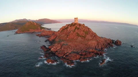 Flight and takeoff over old tower in the sea, Corsica. Aerial view. Stock-Footage 47471271