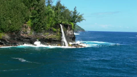 Flight approaching Hawaiian waterfall at ocean's edge Stock Footage 59245141