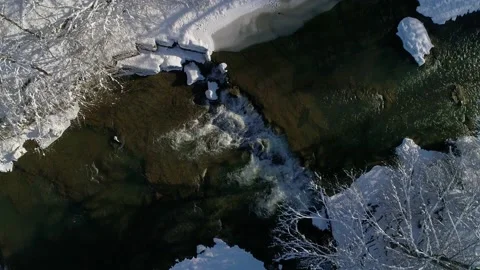 Flight approaching a mountain wild clear river on a winter sunny day. Video stock 232717720