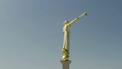 Flight around the Angel Moroni statue on top of the Mormon Temple in Los Stock Footage 137573644