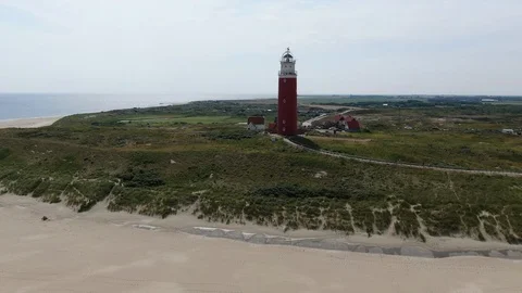 Flight around the old lighthouse on the coast of Texel Island 스톡 동영상 120176366
