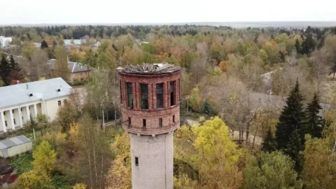 Flight around the old water bath on the background of the village and a beaut Stock Footage 144010461