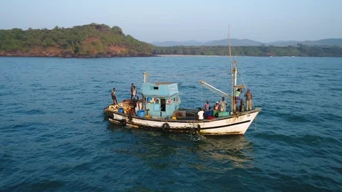Flight around a small old wooden fishing boat that swings heavily on the waves Видео 101993055
