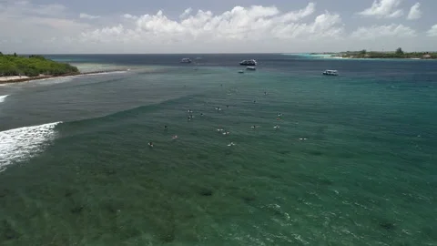 Flight around surf spot. Good waves for surfing. White yachts in the ocean bay.  Stock Footage 160440255
