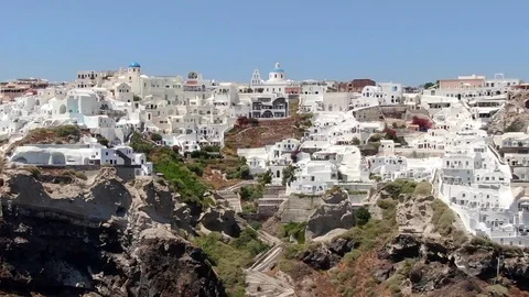Flight around of Three Blue Domes church in Oia town on Santorini island, Greece Video stock 120637382
