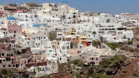 Flight around of Three Blue Domes church in Oia town on Santorini island, Greece Video stock 120637486