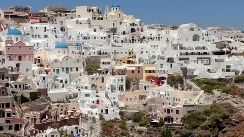 Flight around of Three Blue Domes church in Oia town on Santorini island, Greece Video stock 120637576