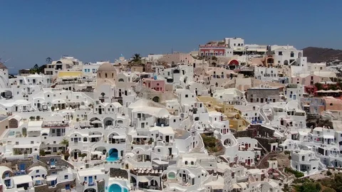 Flight around of Three Blue Domes church in Oia town on Santorini island, Greece Stock Footage 120738471