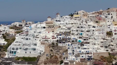 Flight around of Three Blue Domes church in Oia town on Santorini island, Greece Stock Footage 120805547