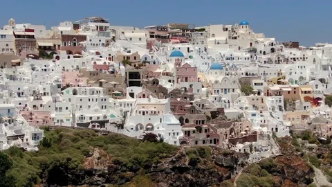 Flight around of Three Blue Domes church in Oia town on Santorini island, Greece Stock Footage 121261112