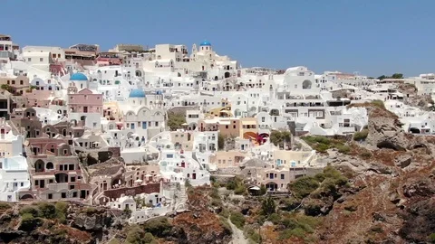 Flight around of Three Blue Domes church in Oia town on Santorini island, Greece Stock Footage 121261182