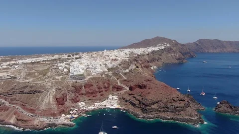 Flight around of Three Blue Domes church in Oia town on Santorini island, Greece Stock Footage 121261281